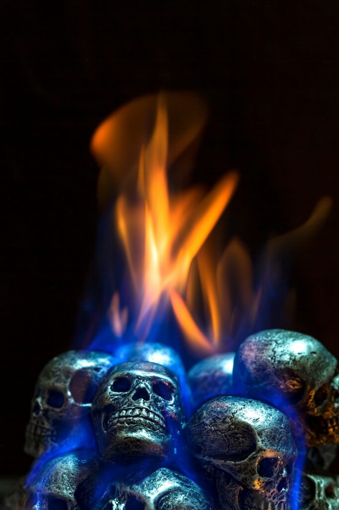 Burning skulls on black background