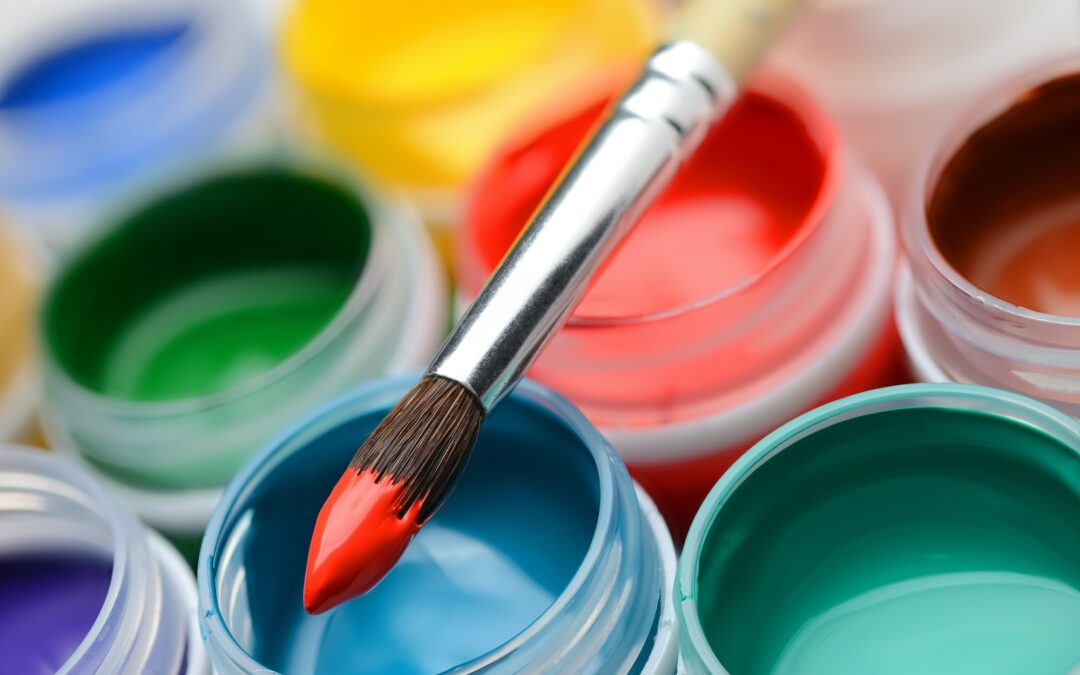 Gouache paint jars and paintbrush
